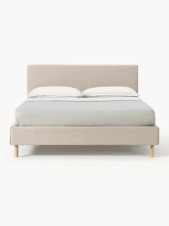 Cama tapizada con patas de madera Giulia