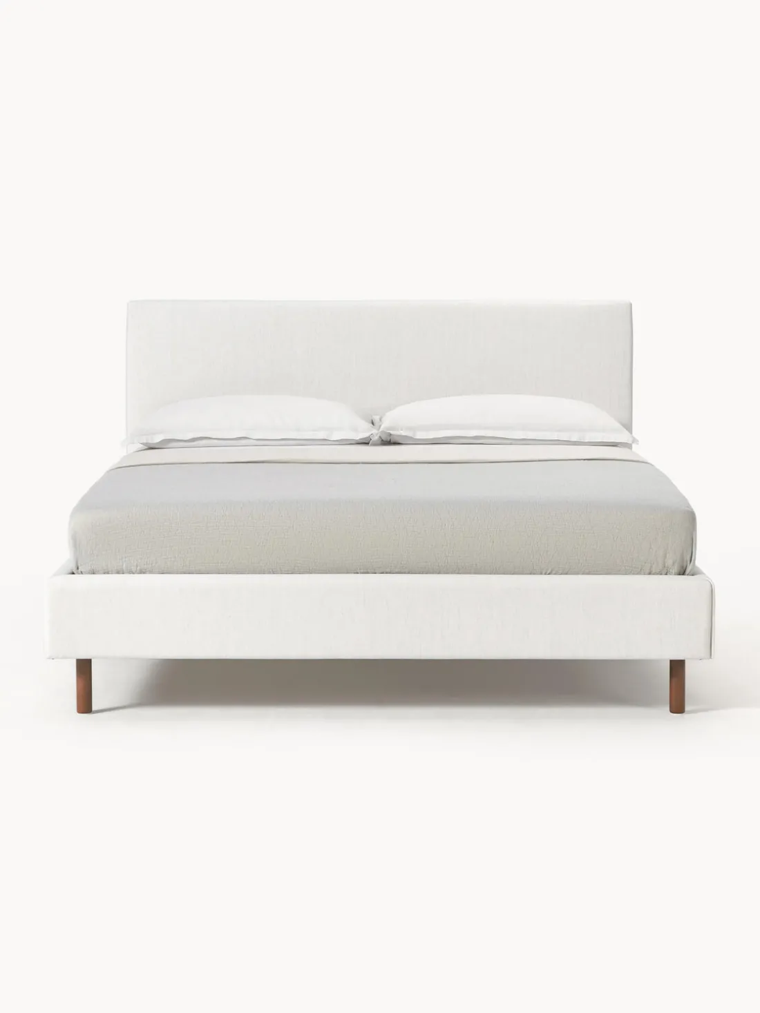Cama tapizada con patas de madera Giulia