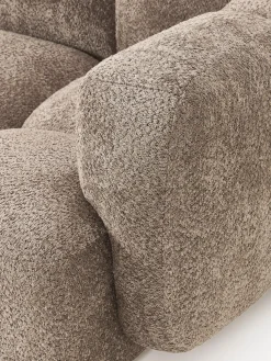 Sofá modular de borreguillo bouclé con reposapiés Tayla (4 plazas)