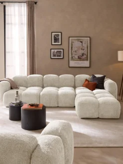 Sofá modular de borreguillo bouclé con reposapiés Tayla (4 plazas)